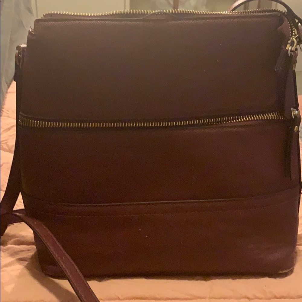 A maroon cross body purse